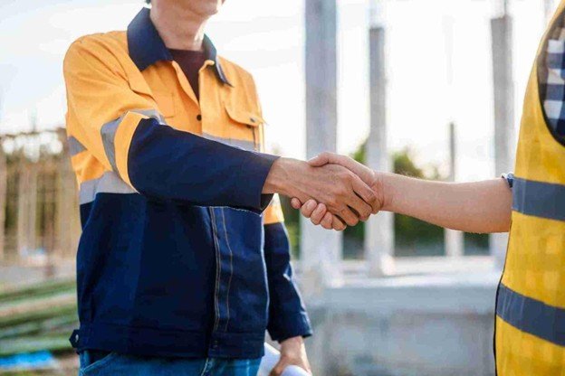 Crownline Tree Service representative shaking hands with a satisfied homeowner after completing professional emergency tree service in University City, MO.